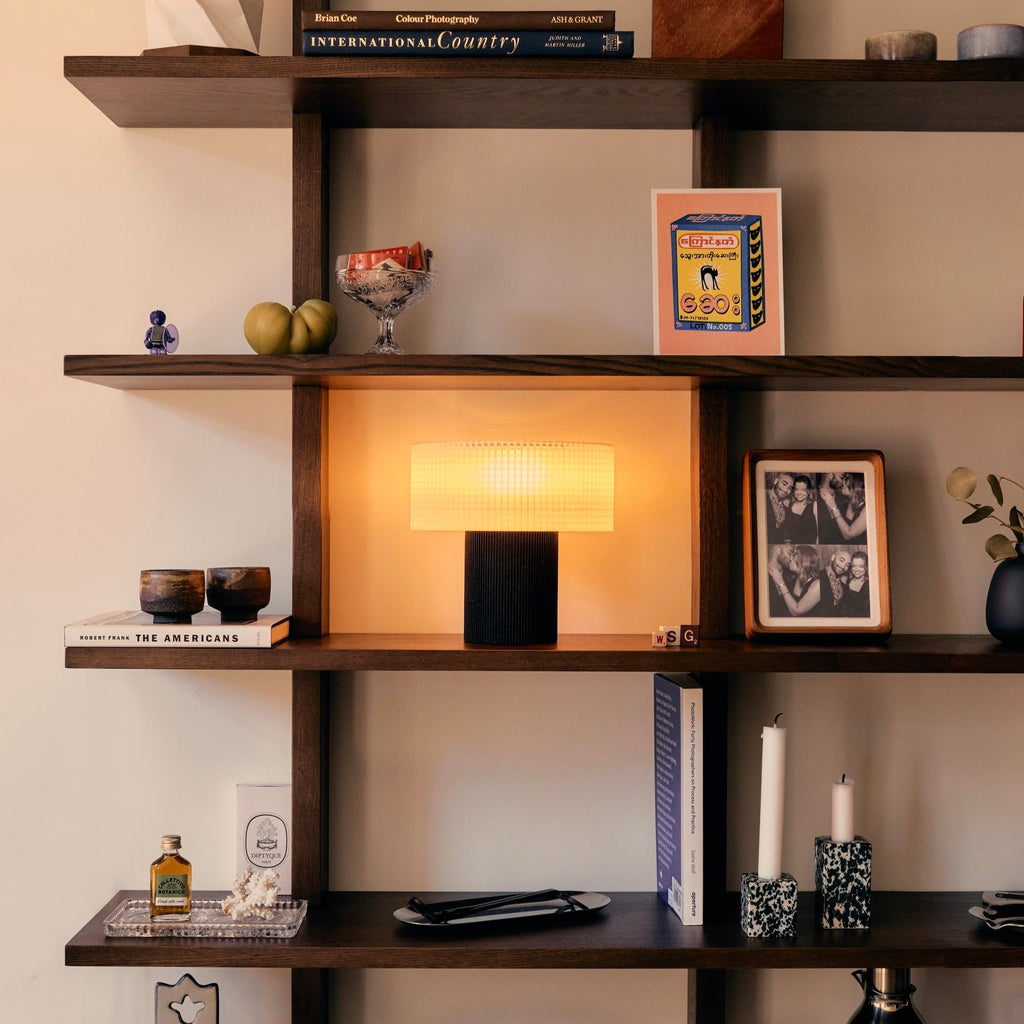 Wooden shelves with decorative items against a neutral wall