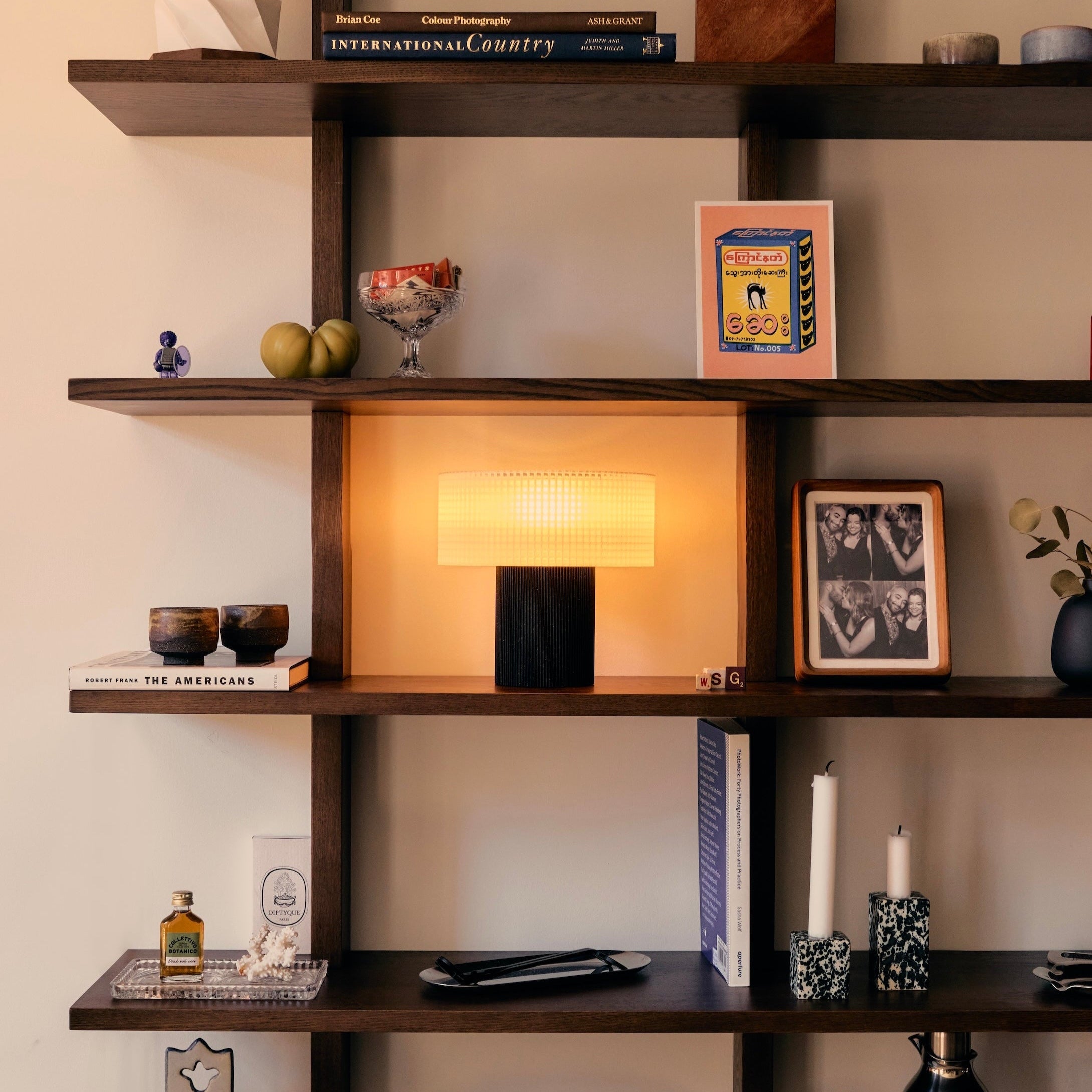 Wooden shelves with decorative items against a neutral wall
